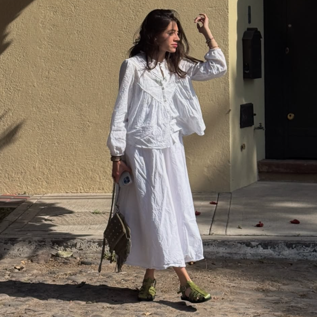 Cayucas Alma, olive green woven leather huarache fisherman sandal worn with white linen dress, handmade in Mexico